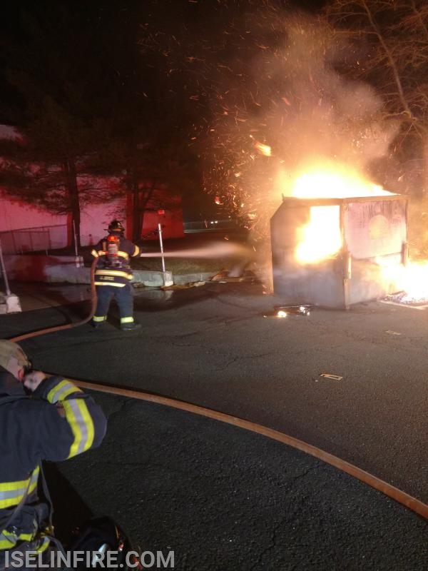 FF/EMT Joyce extinguishes a dumpster fire on Ronson Road, April 4, 2019.