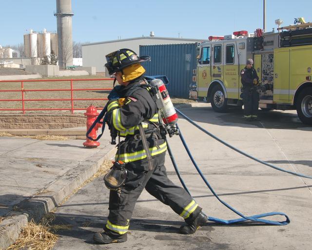 FF Creighton stretches the pre-connect at a live burn drill March 24, 2013.