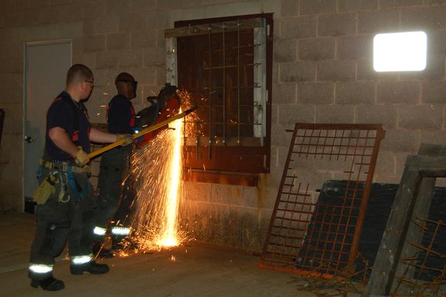 October 11, 2010: Probationary FF Younger and Lt. Hoydis use the K-12 saw to remove window bars during a forcible entry drill at the Somerset County Fire Academy.