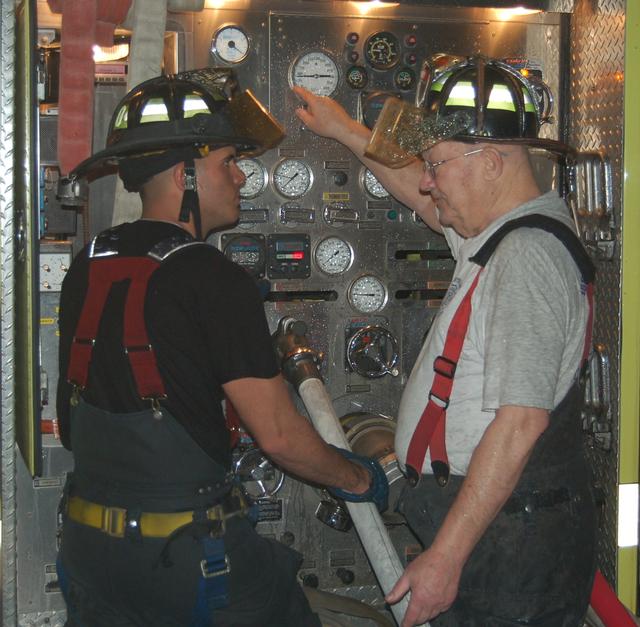 April 5, 2010: Ex-Chief Roger Stewart instructs FF/EMT Valter Pires on how to operate the pump at the live burn drill.