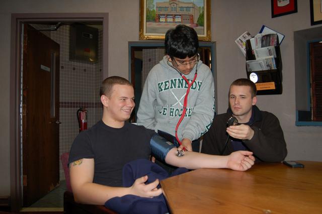 Lokesh Desai practices taking a blood pressure on FF Creighton under the watchful eye of FF/EMT Penna, January 2013.