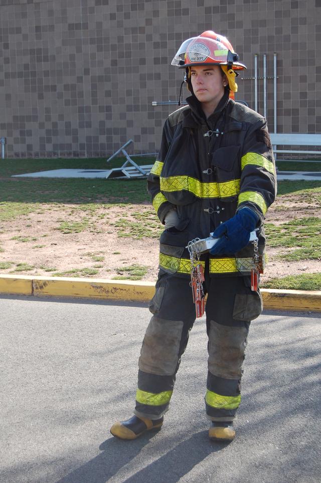 Anthony Harland handles accountability during a live burn drill at the fire academy.