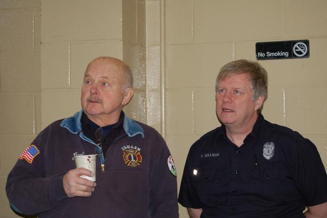 Ex Chief Carl Christensen and Retired FF Bob Sullivan plan how to get to the donuts at the Mayors Brunch on 2/27/11.