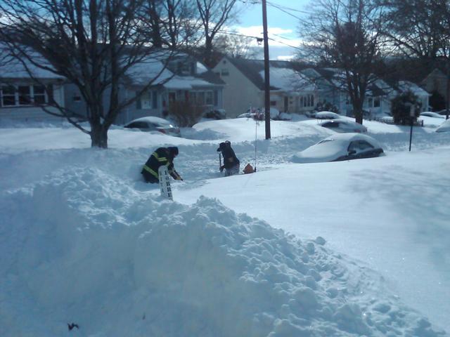 FF Mike Madison and Explorer Nick Farese shovel out a hydrant after the Christmas 2010 blizzard. 